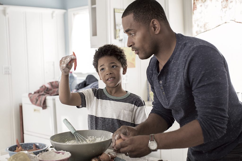 A man and a boy cooking in the kitchen