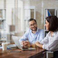 Business meeting of two young colleagues in office