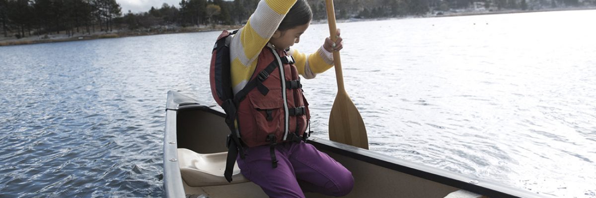 Person paddling in a small canoe.