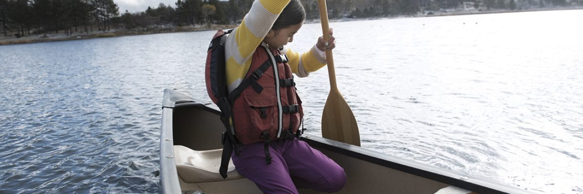 Person paddling in a small canoe. Person paddling in a small canoe.